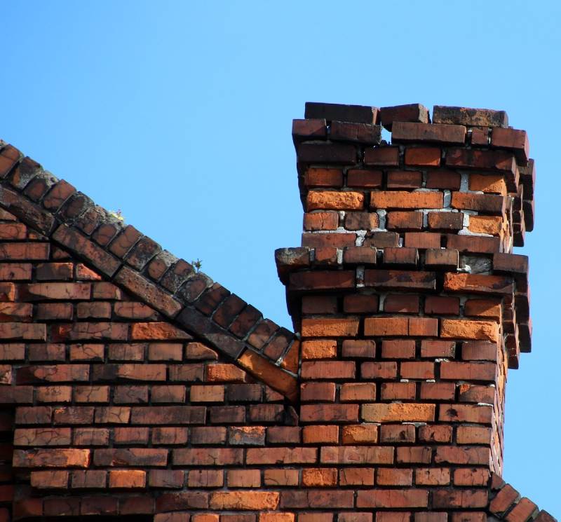 Damaged chimney on an San Juan Capistrano home showing cracks and missing mortar